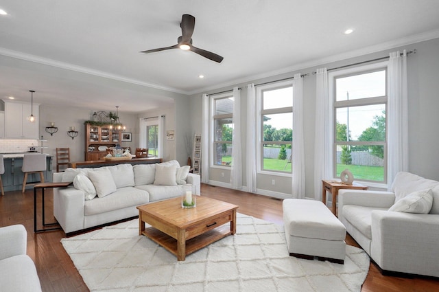 914 W Lorenza Dr, Nixa, MO 65714 - living room featuring crown molding, recessed lighting, a ceiling fan, wood finished floors, and a chandelier