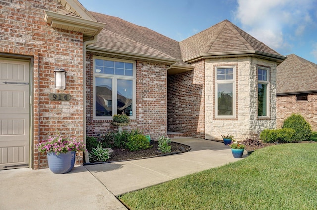 914 W Lorenza Dr, Nixa, MO 65714 - doorway to property featuring a shingled roof, a yard, and brick siding