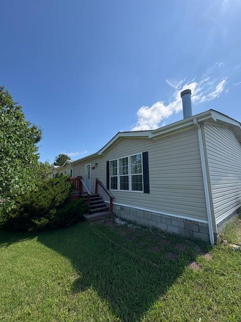64 Inman Dr, Theodosia, MO 65761 - back of property with a lawn and a wooden deck