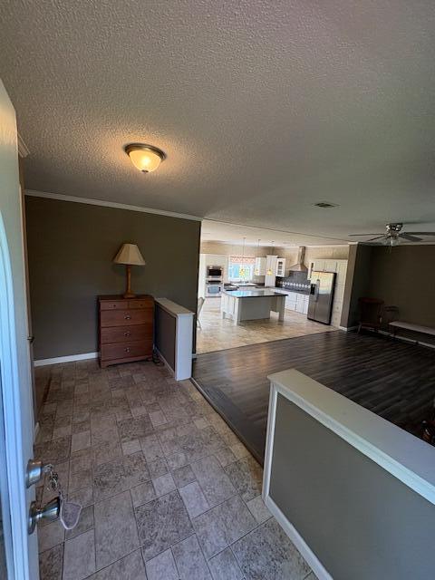 64 Inman Dr, Theodosia, MO 65761 - kitchen featuring stainless steel fridge with ice dispenser, ceiling fan, and a textured ceiling