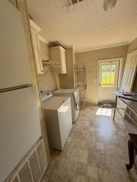 64 Inman Dr, Theodosia, MO 65761 - laundry room featuring cabinet space, washer and clothes dryer, a textured ceiling, and ornamental molding