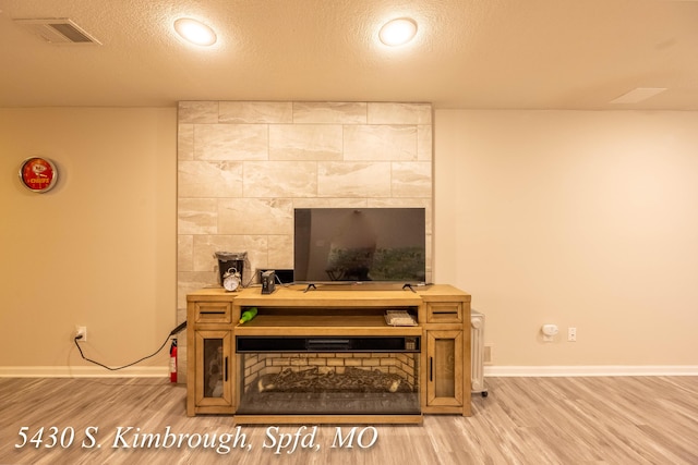 5430 S Kimbrough Ave, Springfield, MO 65810 - detailed view of wood finished floors, a textured ceiling, and a fireplace