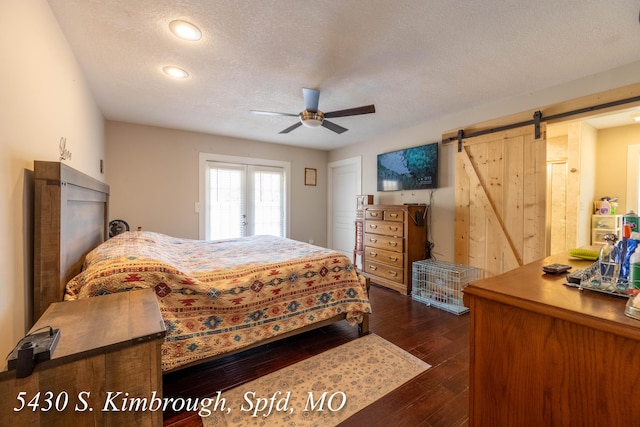 5430 S Kimbrough Ave, Springfield, MO 65810 - bedroom with a barn door, dark wood-type flooring, a textured ceiling, recessed lighting, and a ceiling fan