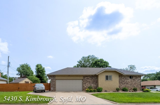 5430 S Kimbrough Ave, Springfield, MO 65810 - view of front of house with a garage, concrete driveway, brick siding, and a shingled roof