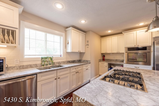 5430 S Kimbrough Ave, Springfield, MO 65810 - kitchen featuring appliances with stainless steel finishes, white cabinets, decorative backsplash, recessed lighting, and light stone countertops