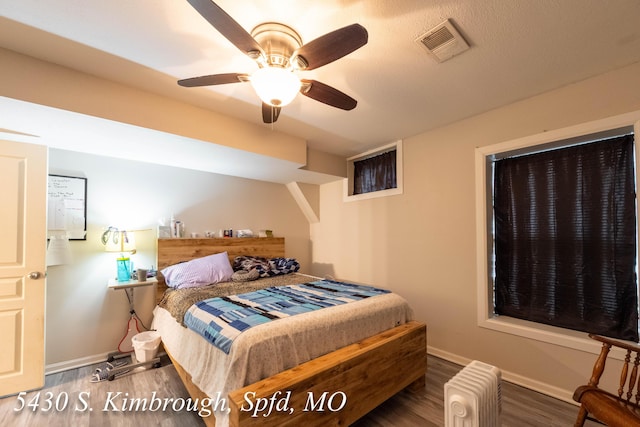 5430 S Kimbrough Ave, Springfield, MO 65810 - bedroom with wood finished floors, radiator, and ceiling fan