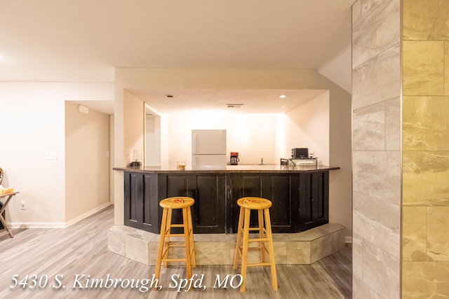 5430 S Kimbrough Ave, Springfield, MO 65810 - indoor wet bar with freestanding refrigerator and wood finished floors