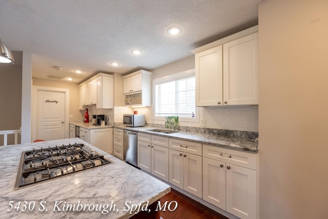 5430 S Kimbrough Ave, Springfield, MO 65810 - kitchen featuring appliances with stainless steel finishes, backsplash, dark wood-style floors, white cabinets, and recessed lighting