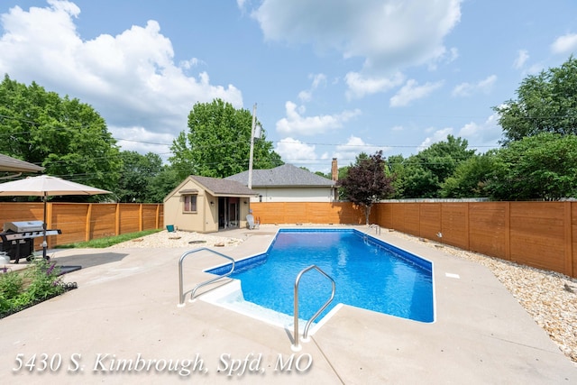 5430 S Kimbrough Ave, Springfield, MO 65810 - view of swimming pool with a fenced backyard, a patio, area for grilling, and an outbuilding
