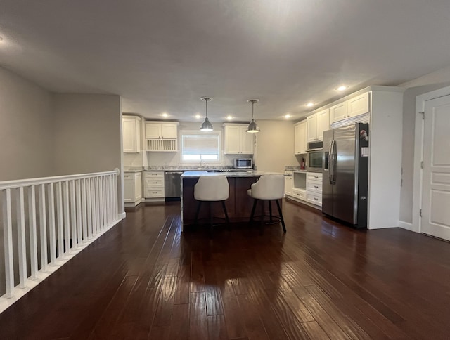 5430 S Kimbrough Ave, Springfield, MO 65810 - kitchen featuring stainless steel appliances, white cabinets, recessed lighting, dark wood finished floors, and a kitchen island