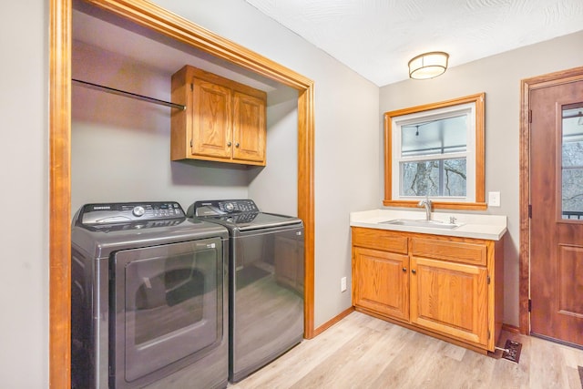 6585 N Farm Rd 61, Walnut Grove, MO 65770 - laundry room with independent washer and dryer, cabinet space, and light wood finished floors