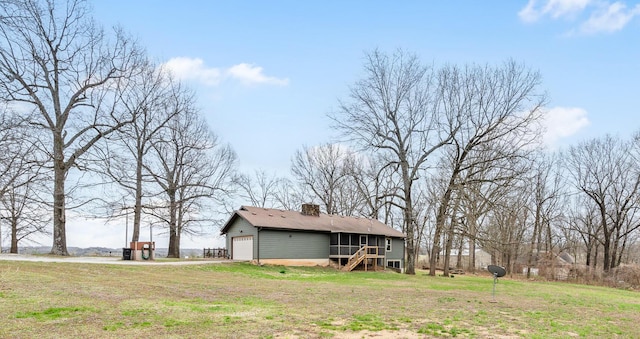 6585 N Farm Rd 61, Walnut Grove, MO 65770 - back of property with a chimney, a lawn, and driveway