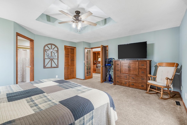 6585 N Farm Rd 61, Walnut Grove, MO 65770 - carpeted bedroom featuring a tray ceiling, a closet, connected bathroom, and ceiling fan