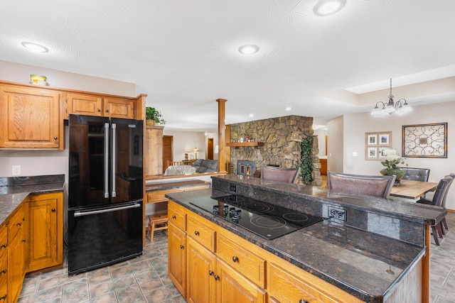 6585 N Farm Rd 61, Walnut Grove, MO 65770 - kitchen with black appliances, open floor plan, a center island, a chandelier, and dark stone counters