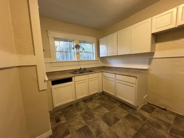 5143 Farm Rd Unit 2000, Pierce City, MO 65723 - kitchen with white cabinetry, stone finish floors, and dark countertops