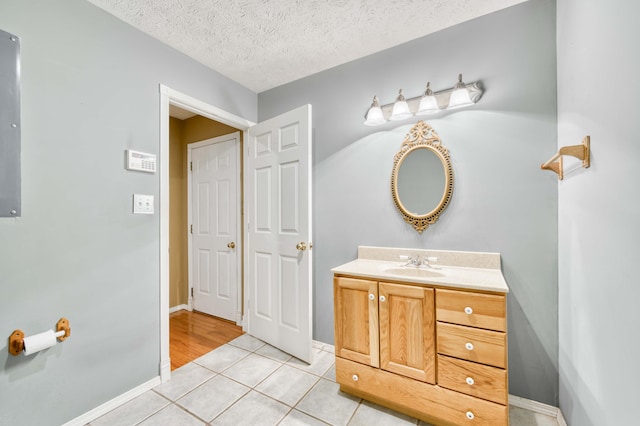 784 S 17th St, Ozark, MO 65721 - bathroom with vanity, tile patterned floors, and a textured ceiling