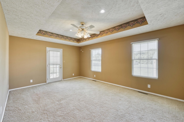 784 S 17th St, Ozark, MO 65721 - carpeted empty room with a textured ceiling, a raised ceiling, and ceiling fan