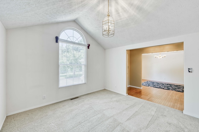 784 S 17th St, Ozark, MO 65721 - carpeted spare room with a chandelier, lofted ceiling, and a textured ceiling