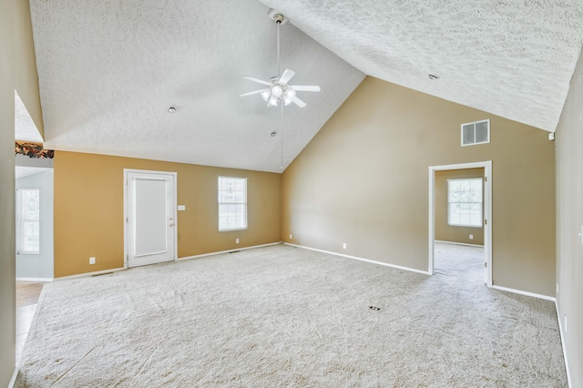 784 S 17th St, Ozark, MO 65721 - unfurnished living room featuring high vaulted ceiling, a ceiling fan, a textured ceiling, and carpet floors