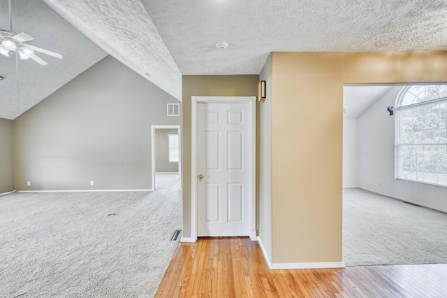784 S 17th St, Ozark, MO 65721 - hallway featuring vaulted ceiling, carpet floors, wood finished floors, and a textured ceiling