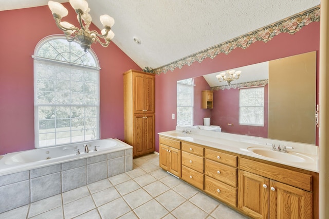 784 S 17th St, Ozark, MO 65721 - bathroom with a chandelier, vaulted ceiling, double vanity, a whirlpool tub, and tile patterned floors