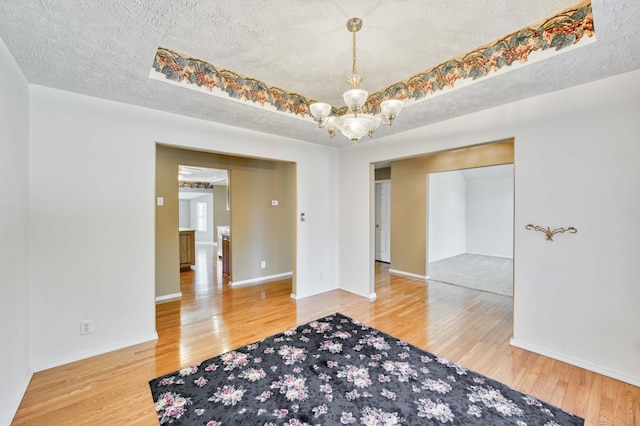 784 S 17th St, Ozark, MO 65721 - spare room featuring a chandelier, wood finished floors, and a textured ceiling