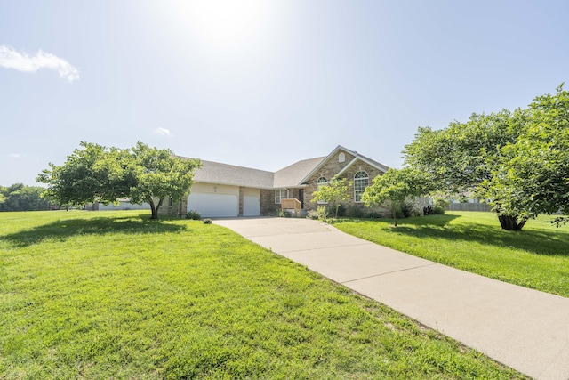 784 S 17th St, Ozark, MO 65721 - view of front of house featuring an attached garage, a front yard, stone siding, and driveway