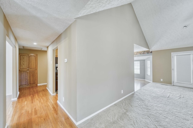 784 S 17th St, Ozark, MO 65721 - hallway featuring a textured ceiling, light wood-type flooring, and lofted ceiling