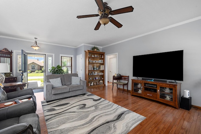 715 W Wasson St, Nixa, MO 65714 - living area featuring a ceiling fan, wood finished floors, and ornamental molding