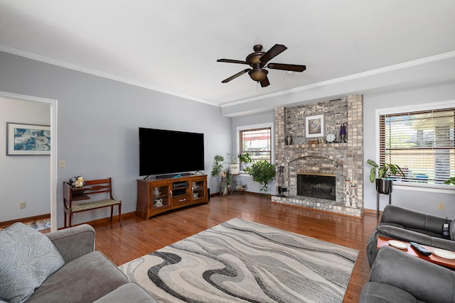 715 W Wasson St, Nixa, MO 65714 - living area featuring ceiling fan, ornamental molding, wood finished floors, and a brick fireplace
