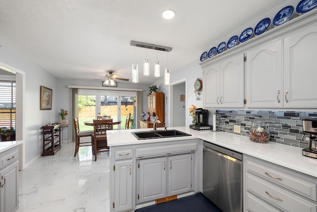 715 W Wasson St, Nixa, MO 65714 - kitchen with stainless steel dishwasher, a peninsula, light marble finish floors, decorative backsplash, and ceiling fan