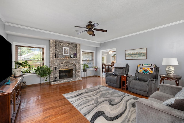 715 W Wasson St, Nixa, MO 65714 - living room with ceiling fan, wood finished floors, crown molding, and a fireplace
