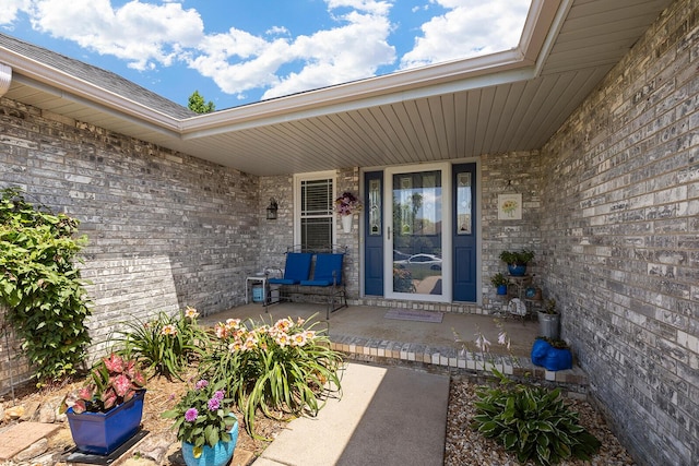 715 W Wasson St, Nixa, MO 65714 - view of exterior entry featuring covered porch and brick siding