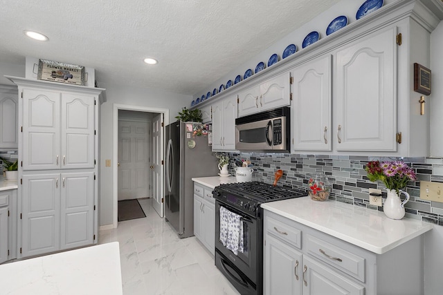 715 W Wasson St, Nixa, MO 65714 - kitchen with appliances with stainless steel finishes, light marble finish flooring, light countertops, recessed lighting, and backsplash