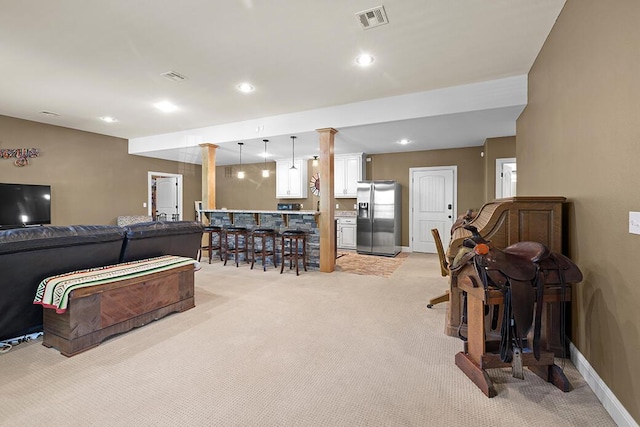 2741 Summit Dr, Joplin, MO 64804 - living area with light carpet, a bar, recessed lighting, and decorative columns