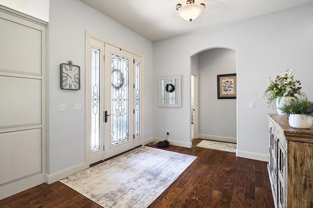 2741 Summit Dr, Joplin, MO 64804 - foyer entrance featuring arched walkways, healthy amount of natural light, and dark wood-type flooring