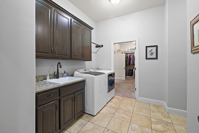 2741 Summit Dr, Joplin, MO 64804 - laundry area featuring cabinet space, washing machine and dryer, light tile patterned floors, and light colored carpet