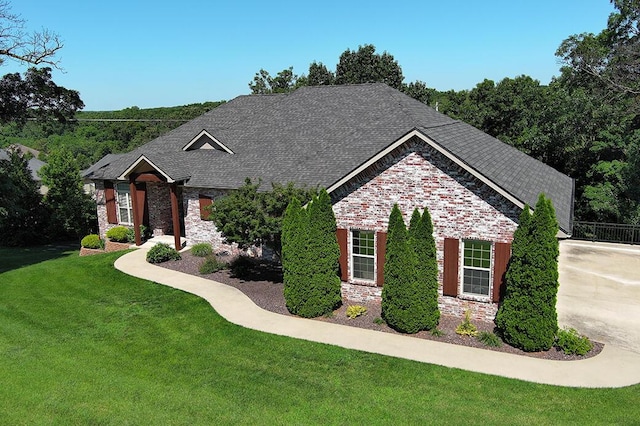 2741 Summit Dr, Joplin, MO 64804 - view of front of home featuring a front lawn, stone siding, driveway, and roof with shingles
