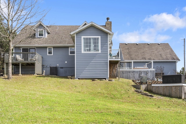 859 Crows Nest Trl, Branson, MO 65616 - back of property with a deck, a chimney, a yard, and roof with shingles