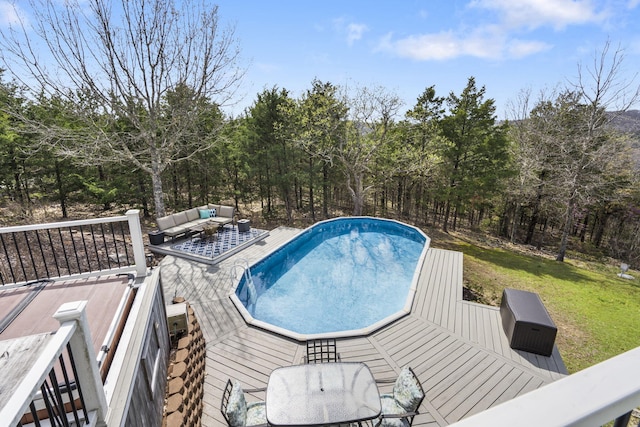 859 Crows Nest Trl, Branson, MO 65616 - swimming pool with an outdoor hangout area, a wooden deck, a yard, and outdoor dining space