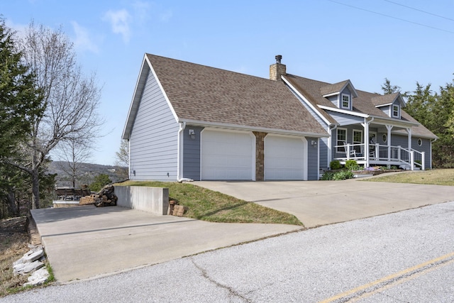 859 Crows Nest Trl, Branson, MO 65616 - view of front of property with a porch, a garage, a chimney, concrete driveway, and a shingled roof