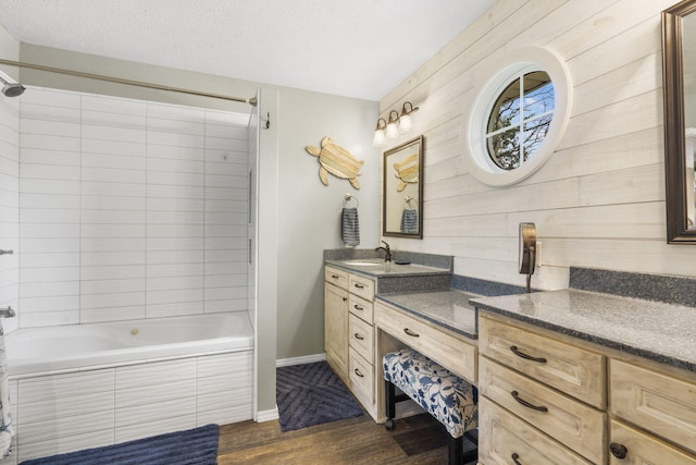 859 Crows Nest Trl, Branson, MO 65616 - full bathroom with wood finished floors, vanity, tiled shower / bath combo, wooden walls, and a textured ceiling