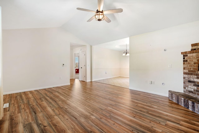 1035 Scenic View Rd, Ozark, MO 65721 - unfurnished living room with a ceiling fan, wood finished floors, a chandelier, and vaulted ceiling