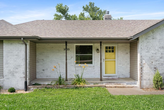 1035 Scenic View Rd, Ozark, MO 65721 - view of exterior entry featuring a porch, a shingled roof, a chimney, brick siding, and a lawn