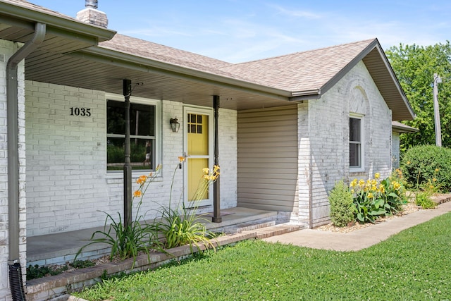 1035 Scenic View Rd, Ozark, MO 65721 - doorway to property with a shingled roof, a chimney, a porch, brick siding, and a lawn