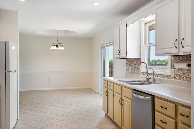 1035 Scenic View Rd, Ozark, MO 65721 - kitchen with dishwasher, freestanding refrigerator, decorative backsplash, light countertops, and pendant lighting