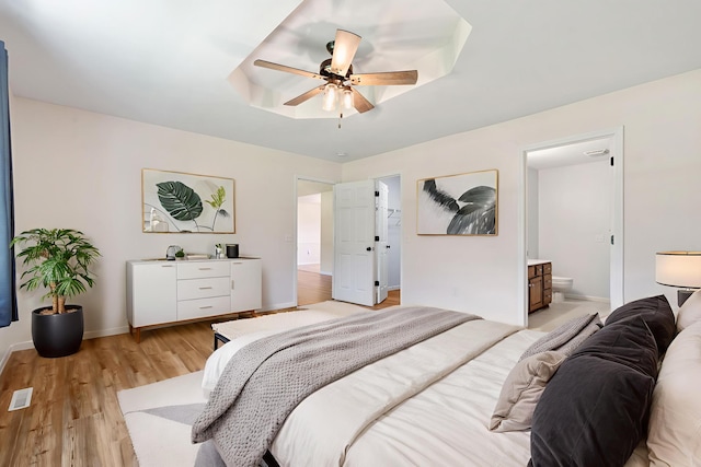 1035 Scenic View Rd, Ozark, MO 65721 - bedroom with light wood-type flooring, ensuite bath, and a ceiling fan