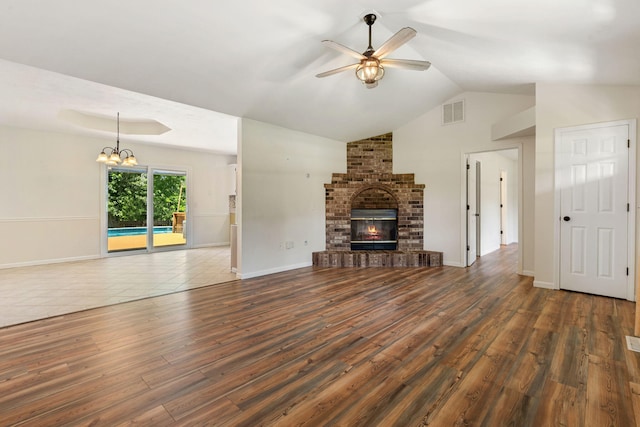 1035 Scenic View Rd, Ozark, MO 65721 - unfurnished living room with a ceiling fan, a chandelier, wood finished floors, lofted ceiling, and a fireplace