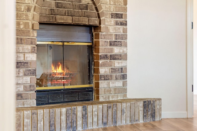 1035 Scenic View Rd, Ozark, MO 65721 - detailed view of a brick fireplace and wood finished floors