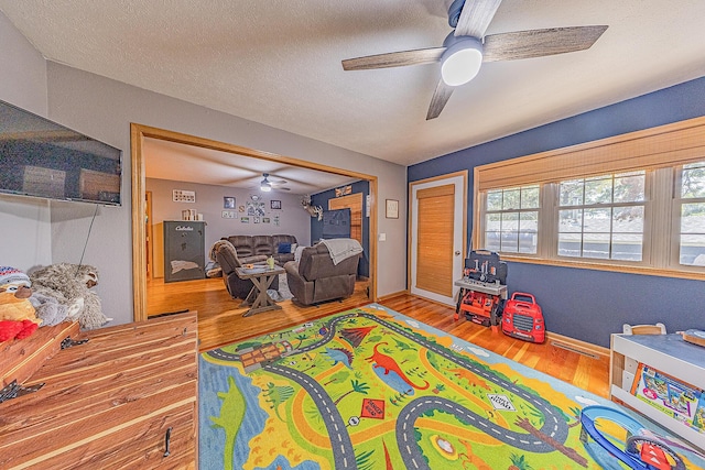 26015 County Road 262, Hermitage, MO 65668 - playroom with a ceiling fan, wood finished floors, and a textured ceiling